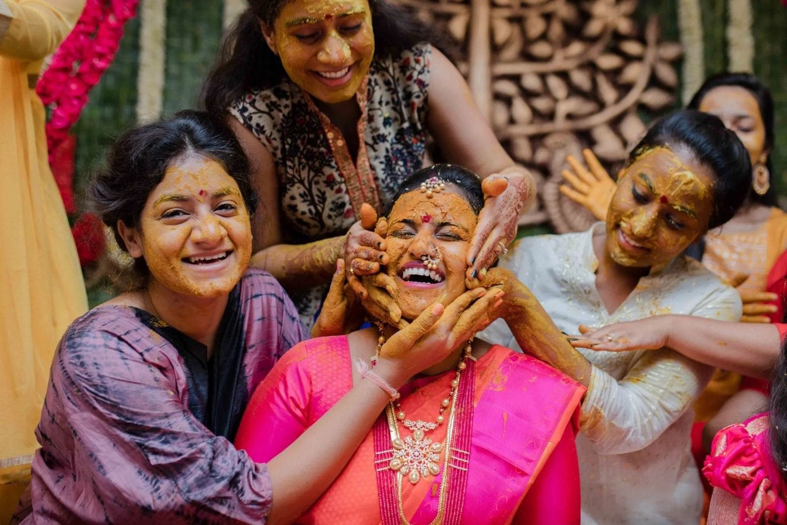 Groom covering the bride’s eyes during a candid haldi moment