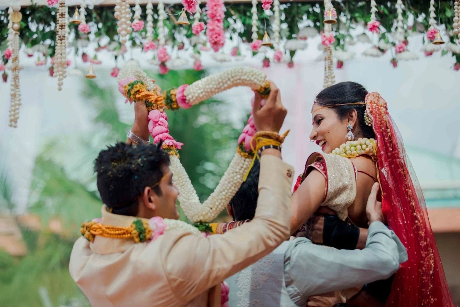Couple exchanging wedding garlands